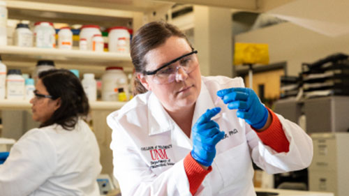 Photo of female pharmacy student holding a sample